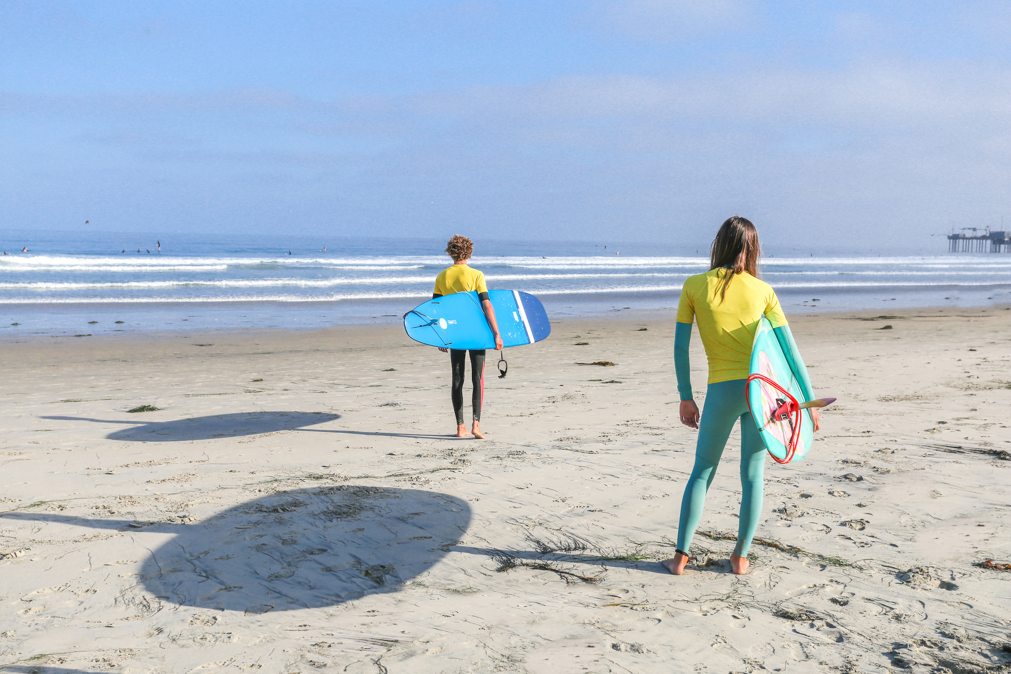 Surf Diva instructor teaching beginner how to learn to surf at La Jolla beach.
